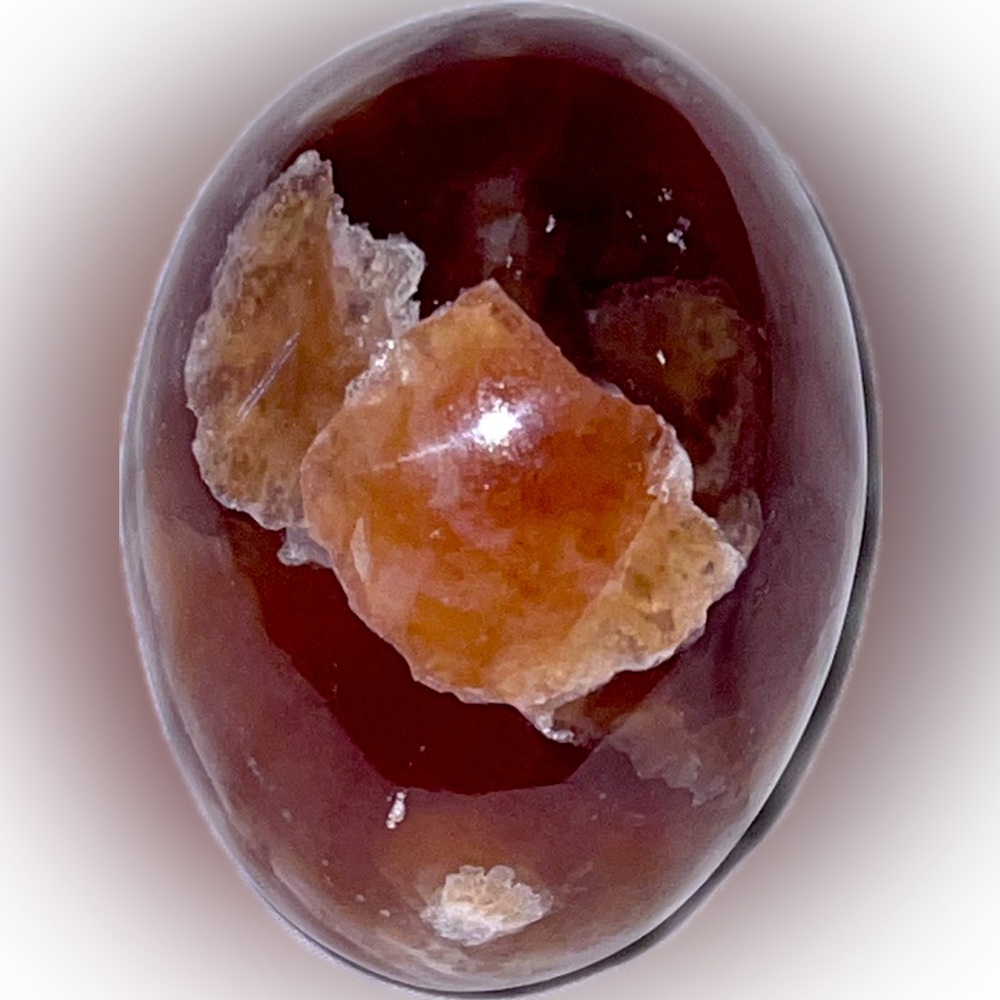 Carnelian gemstone egg with raw druzy crystal inclusion